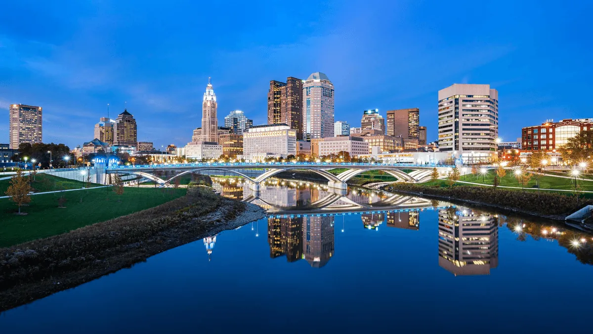 Columbus Ohio downtown skyline with Scioto River reflections and LeVeque Tower at golden hour