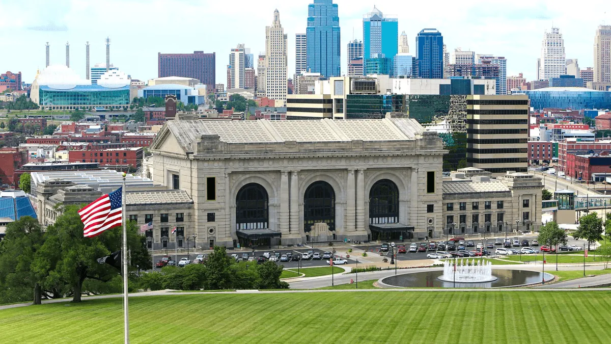 Kansas City Missouri skyline featuring the Country Club Plaza, Union Station, and Liberty Memorial tower at dusk