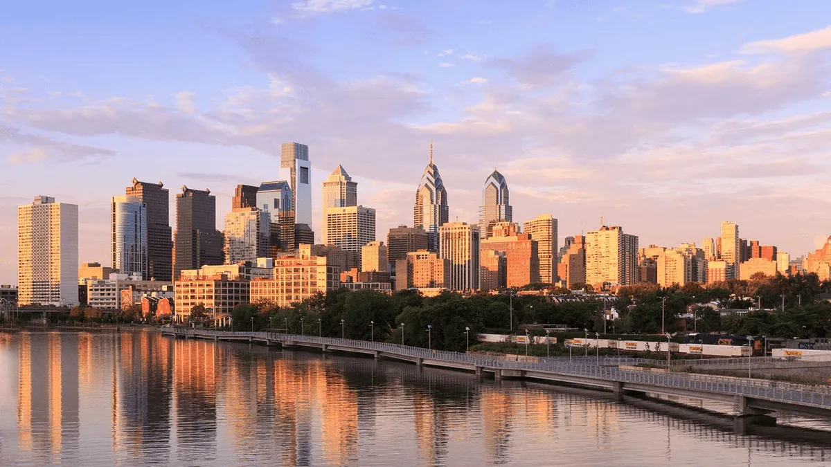 Philadelphia Pennsylvania skyline featuring the Philadelphia Museum of Art, Comcast Technology Center, and Schuylkill River waterfront at golden hour